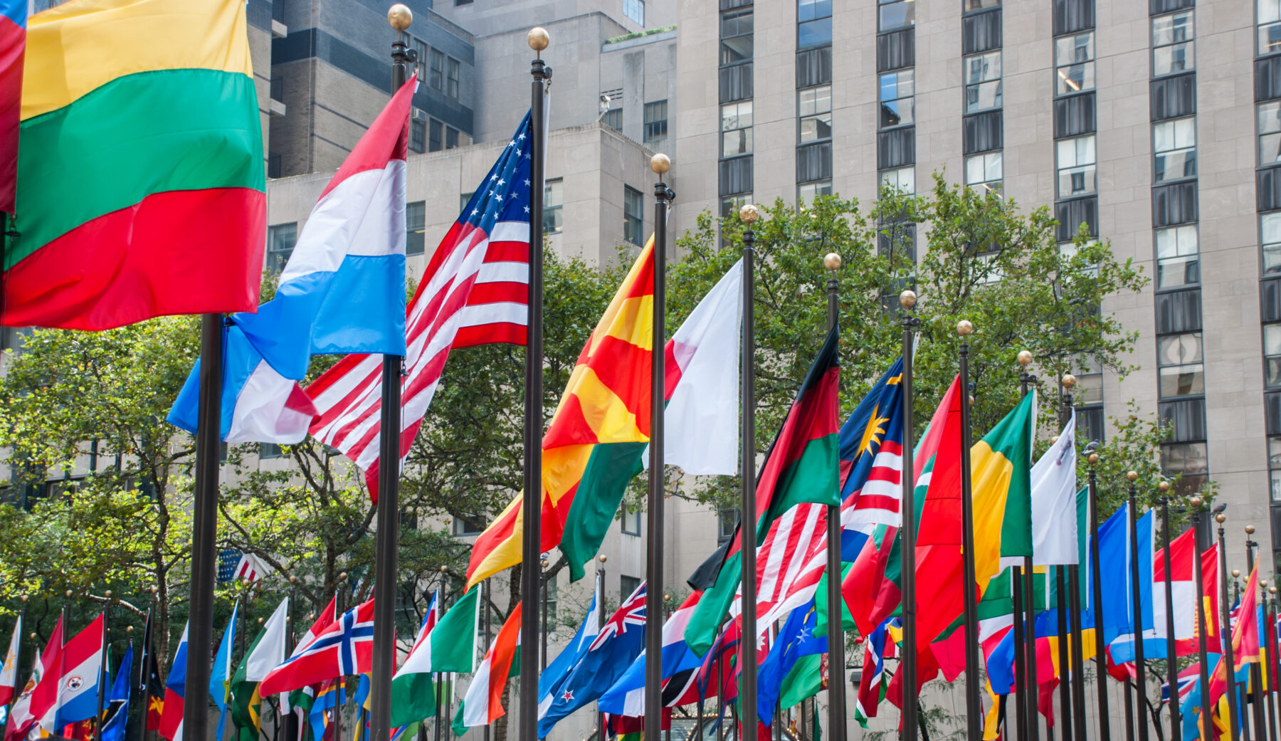 Rows of flags of all nations next to UN in New York City