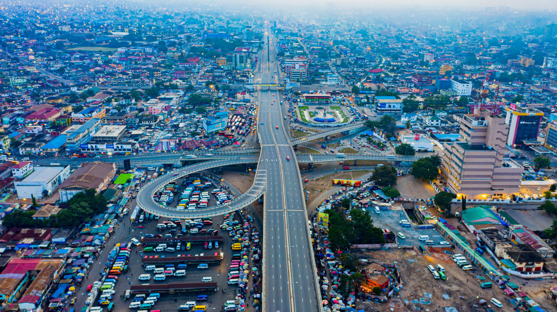 Ghana Accra, Aerial view of a bustling urban area with a major highway and traffic interchange.