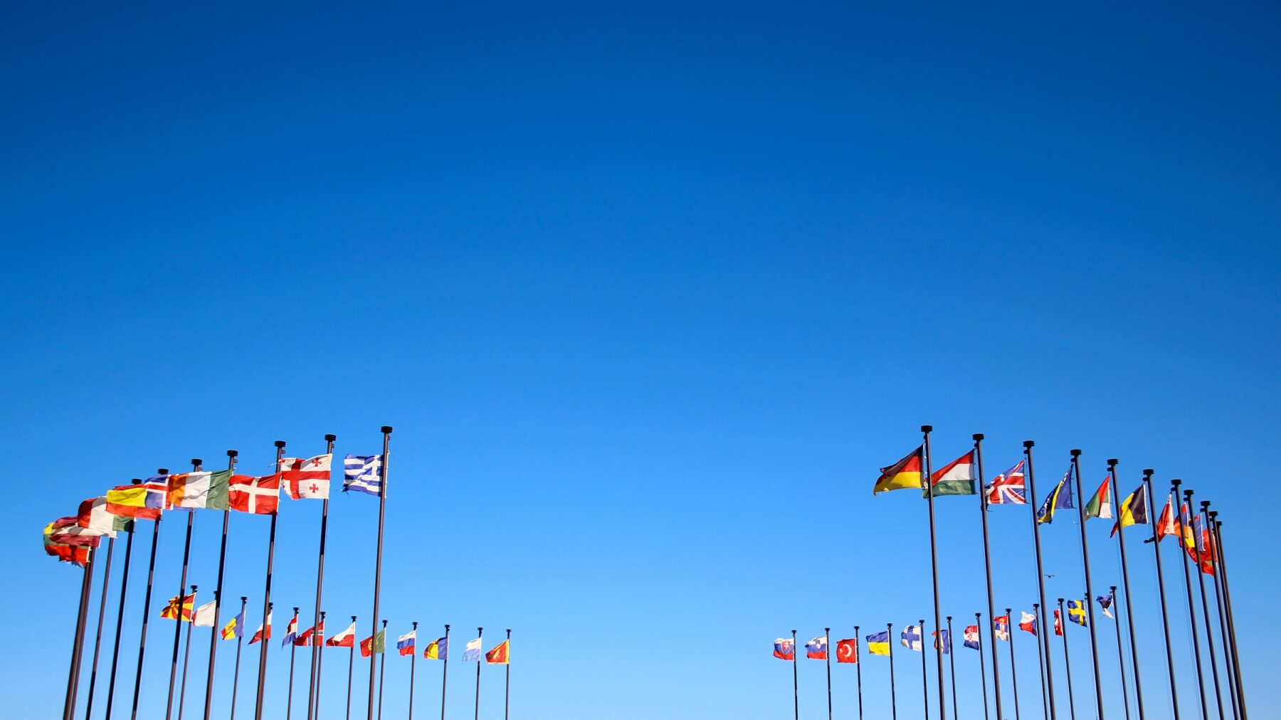 International flags in the wind against the sky